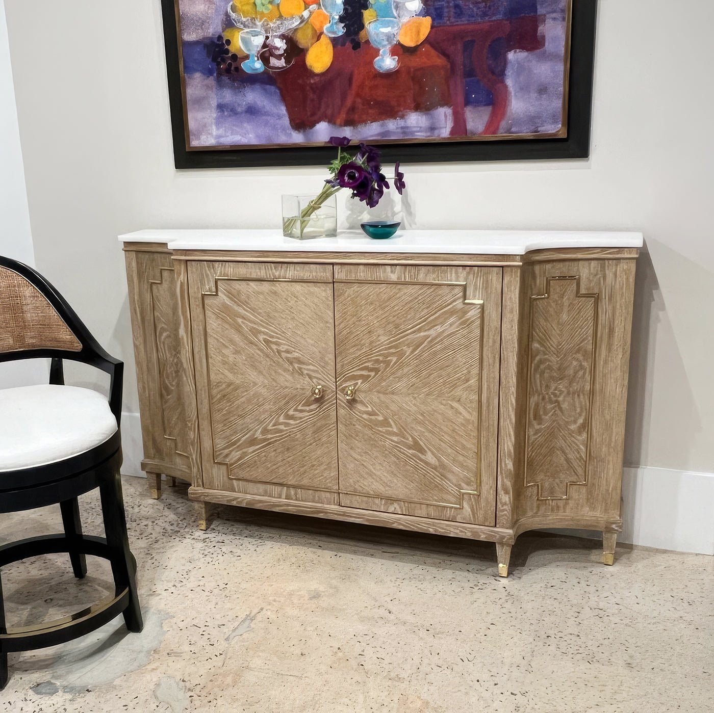 Mid Century oak sideboard in room setting, art on wall.
