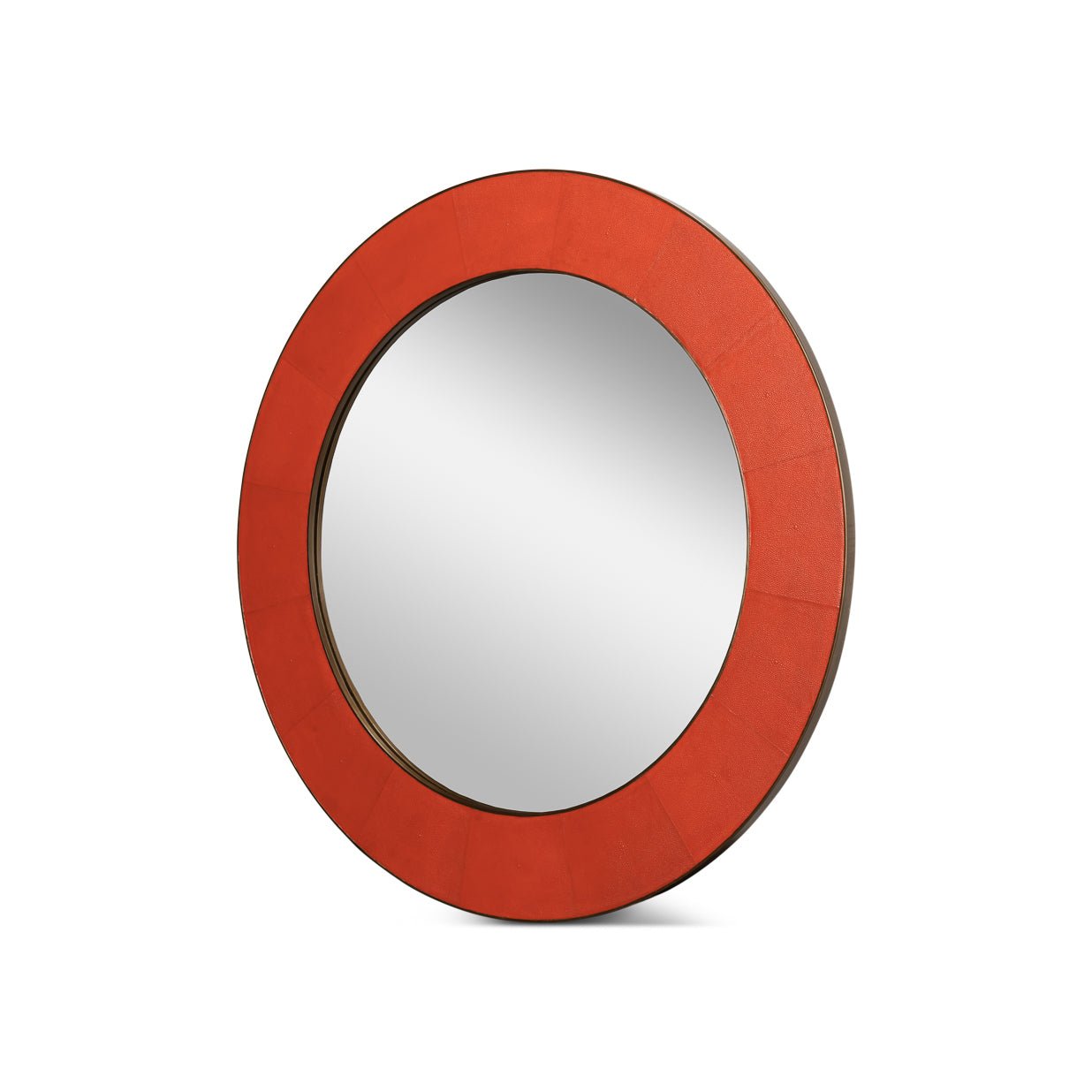 Side angle, orange round leather mirror with reflective surface.