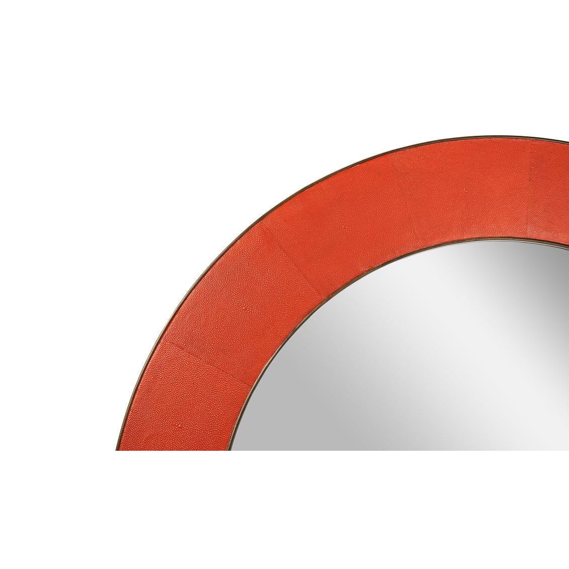 Close-up of orange leather frame on round mirror.