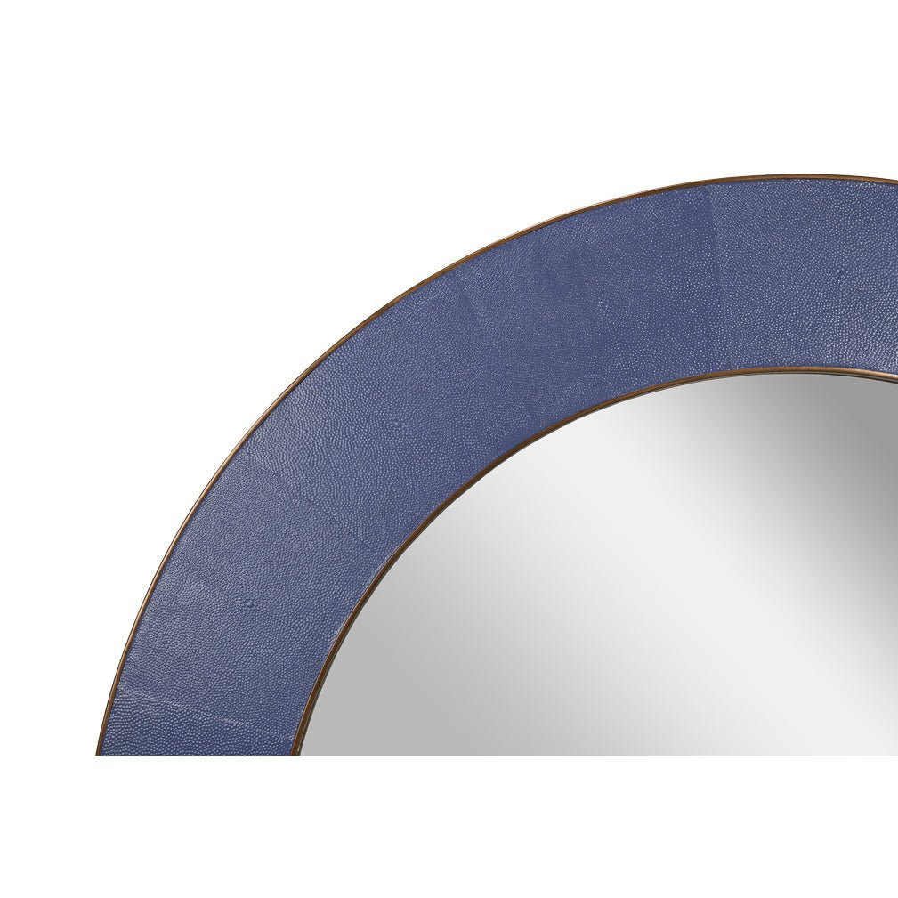 Close-up of round purple mirror's textured leather frame.