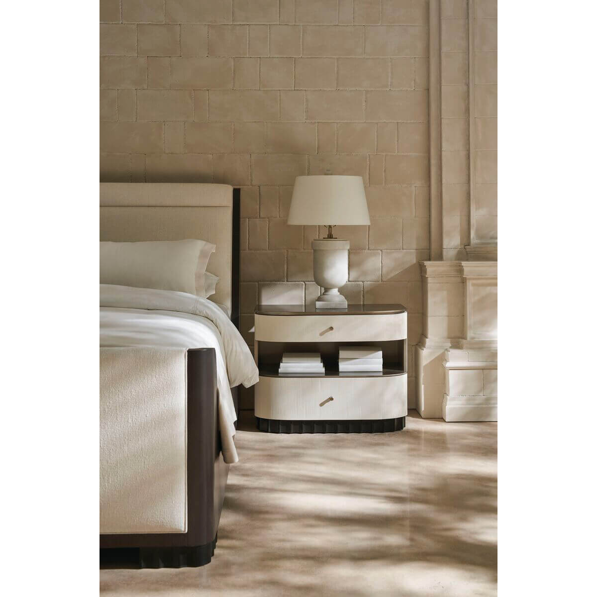 Bedside view of mid-century queen sleigh bed and lamp.