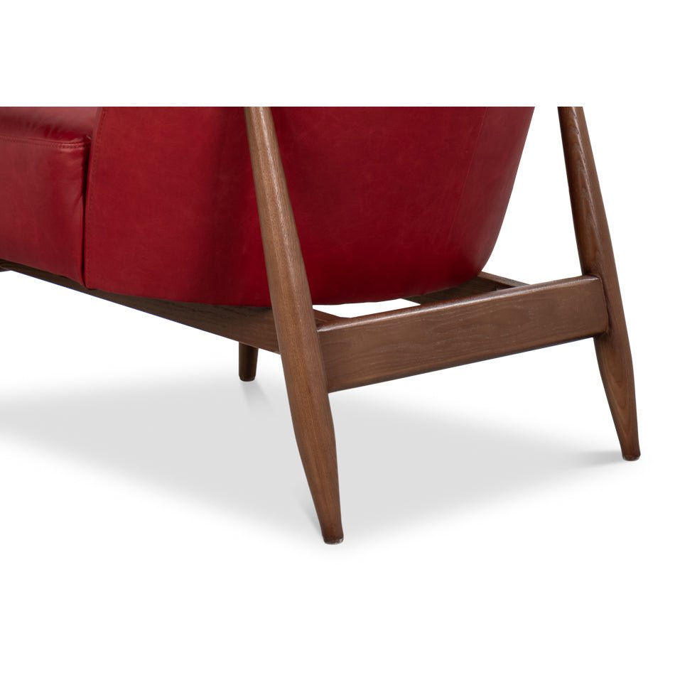 Leg and frame detail red leather armchair mid-century.