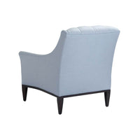Back view of light blue tufted armchair.