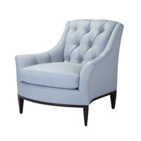 Light blue tufted armchair in angled view.