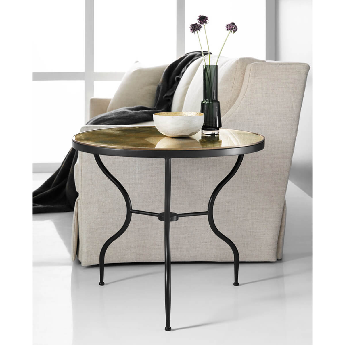 Side table beside sofa with decorative items.