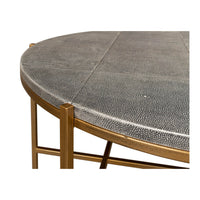 Round leather cocktail table, close-up of texture and frame.