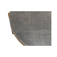 Round leather cocktail table, edge detail, patterned surface.