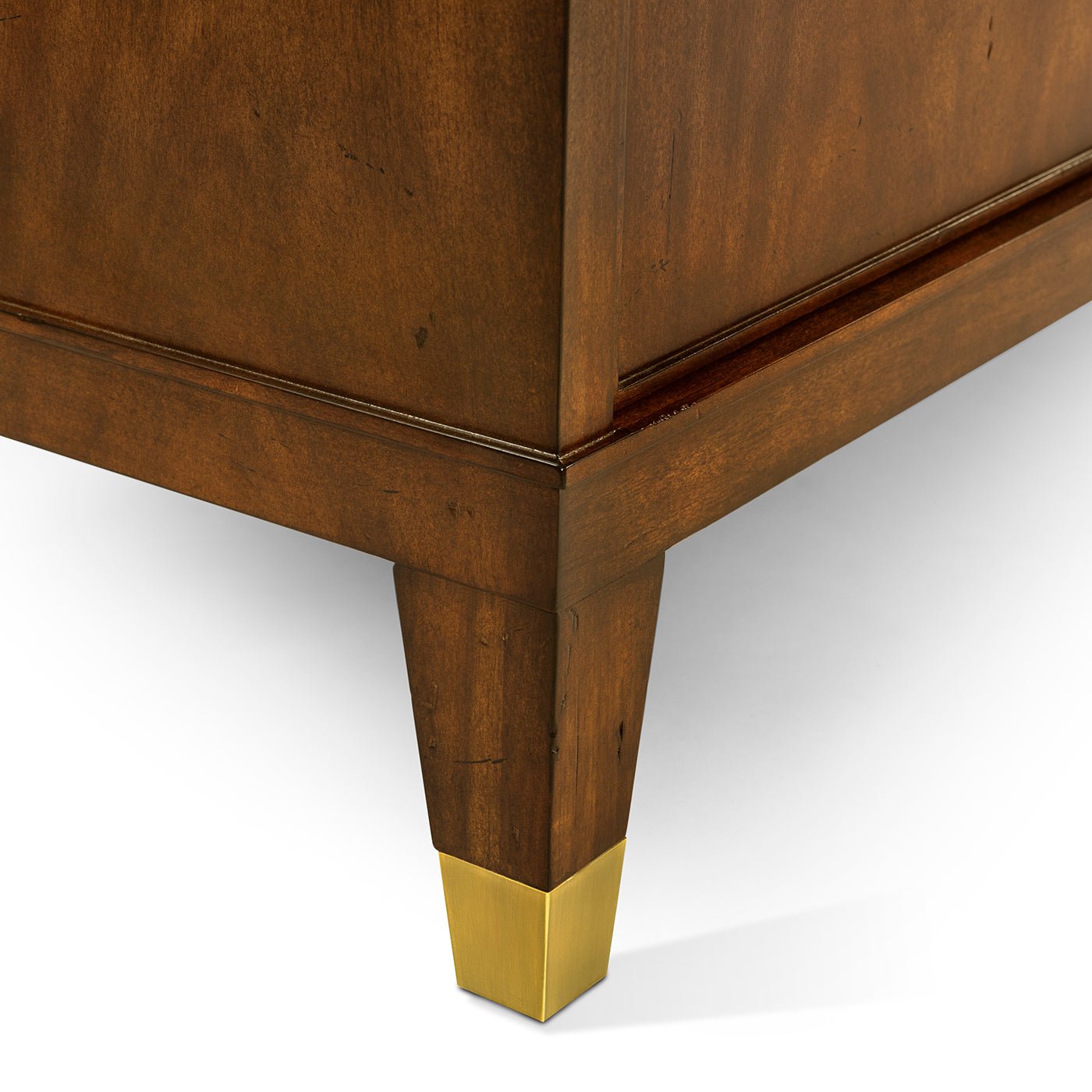 Close-up of mid century sideboard leg with gold accent.