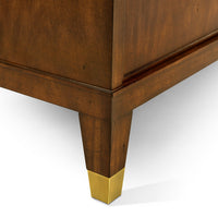 Close-up of mid century sideboard leg with gold accent.