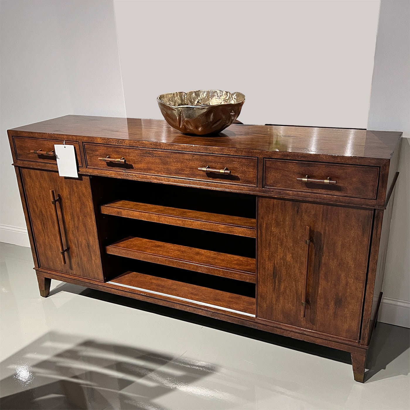Mid century sideboard with decorative bowl, showroom setting.