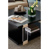 Square coffee table styled with decor, close-up shot.