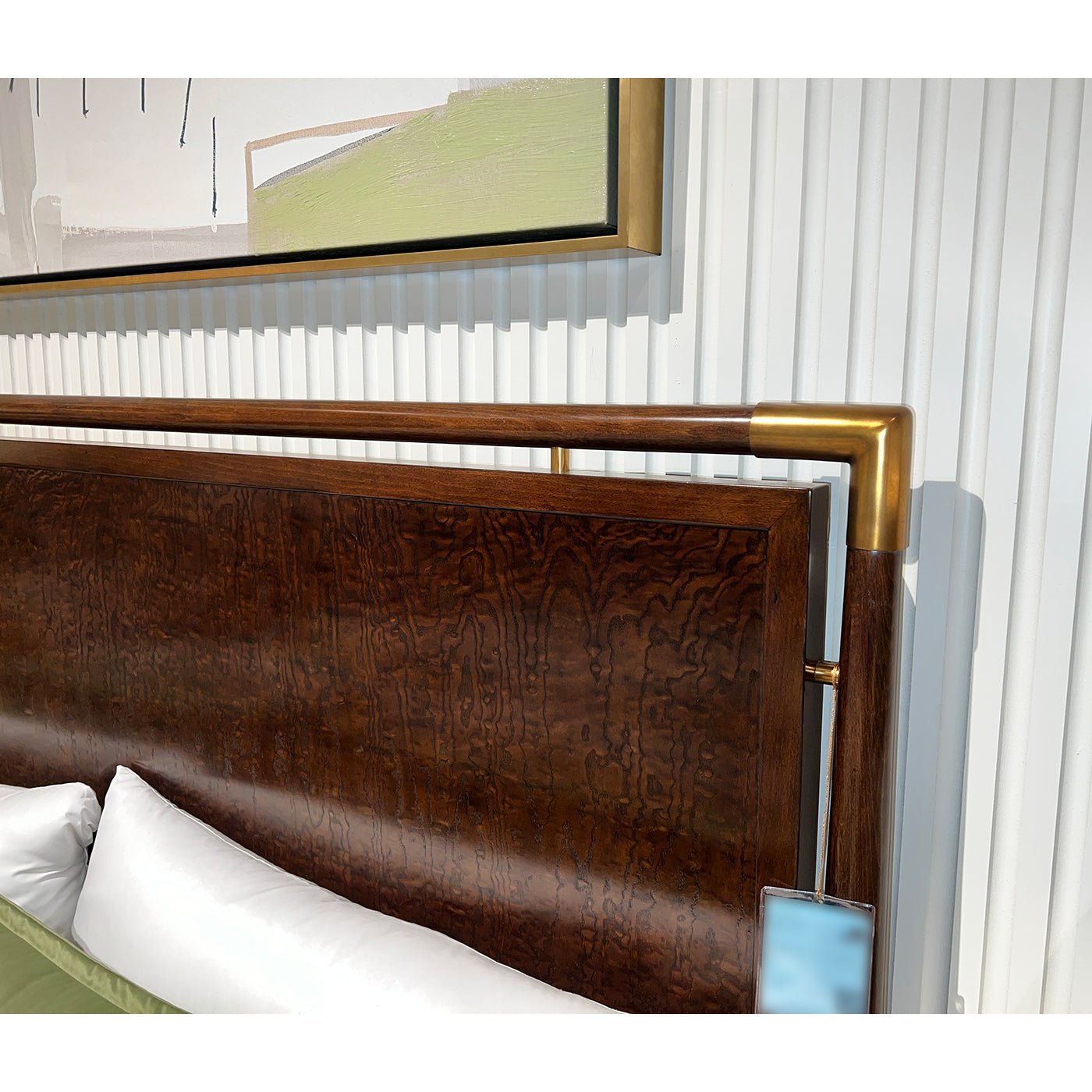 Detailed view of bed headboard with metal corners.