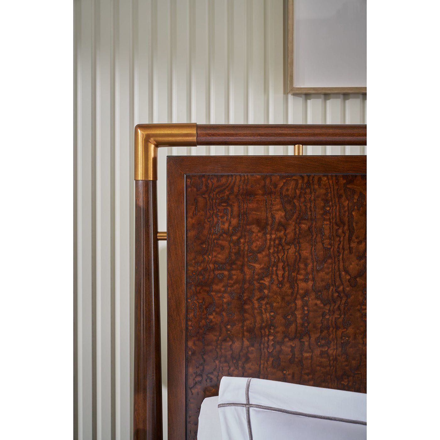 Close-up of mid-century bed headboard with metal accents.