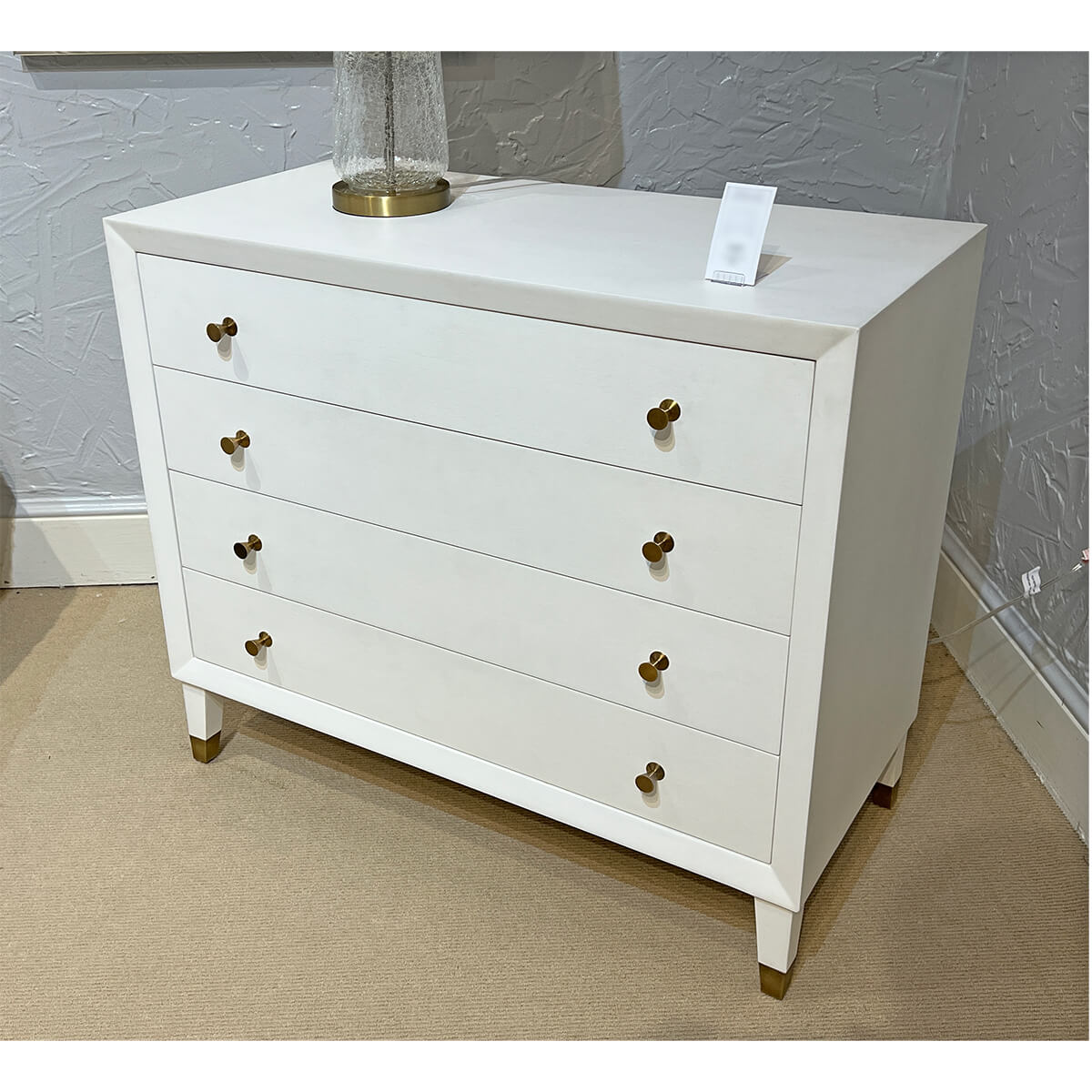 White mid-century dresser in room setting.