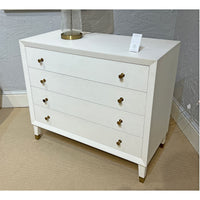 White mid-century dresser in room setting.