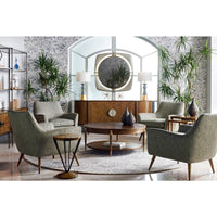 Styled living room with mid-century round coffee table.