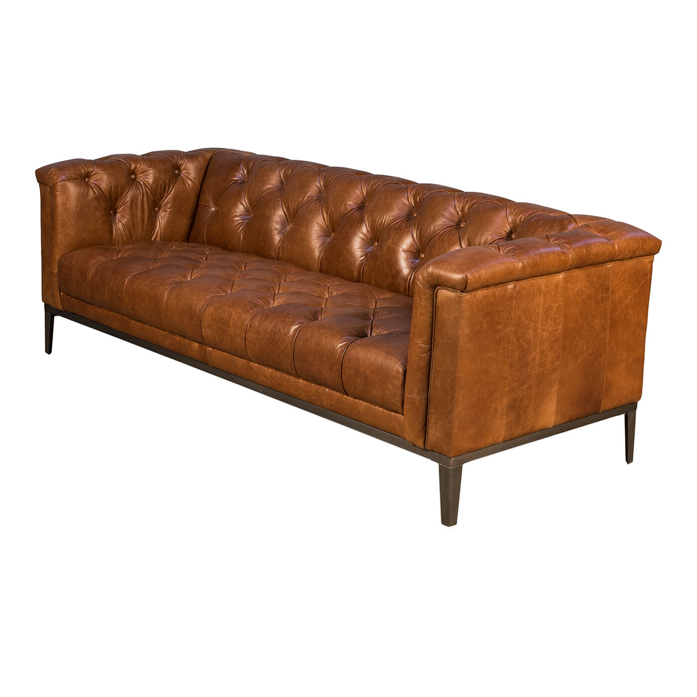 Brown leather tufted sofa, angled view, wooden legs.
