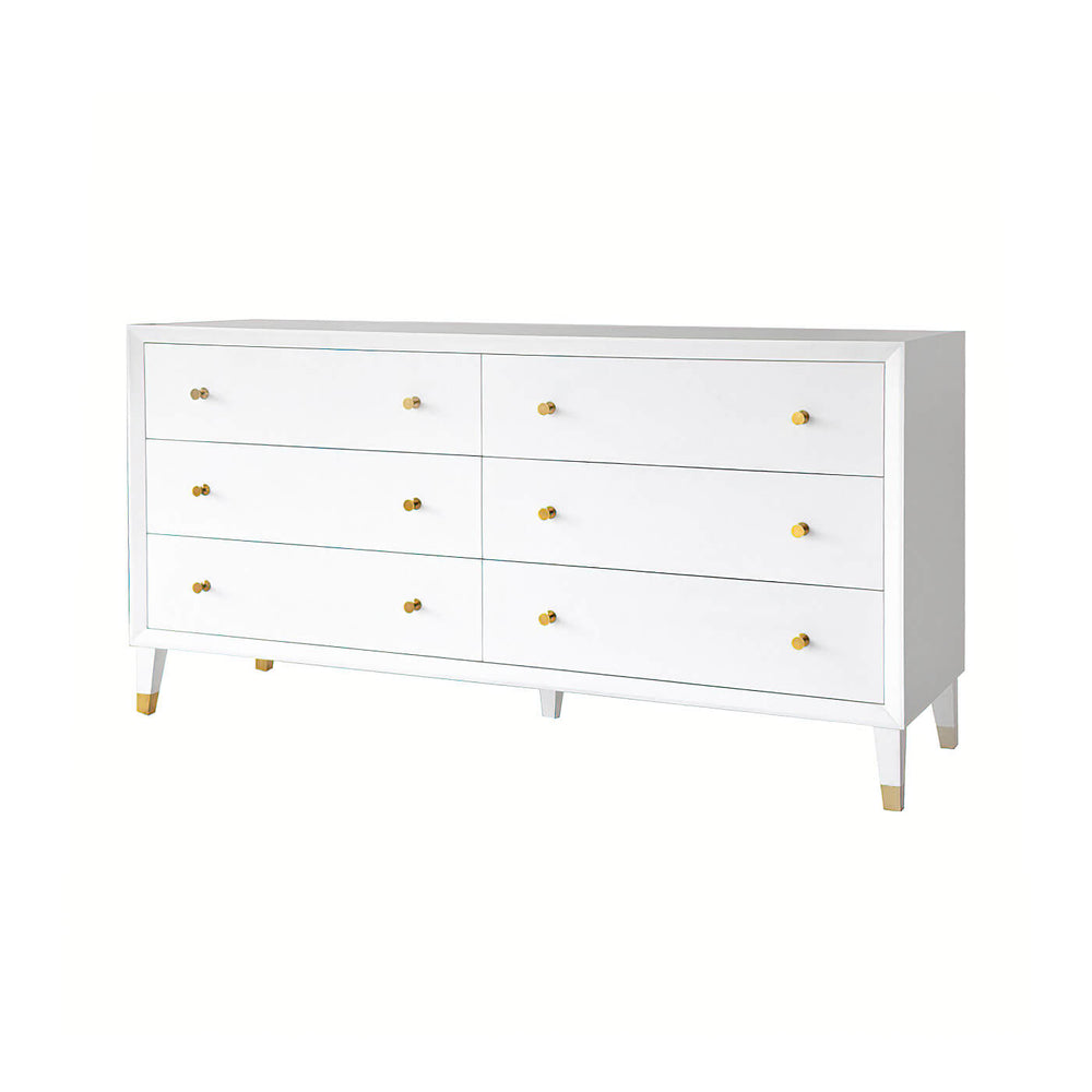 White dresser; six closed drawers, gold knobs, mid-century style.