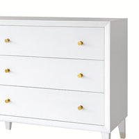 White dresser; top section with three drawers, gold knobs.