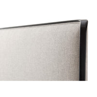 Close-up of beige headboard with black trim.
