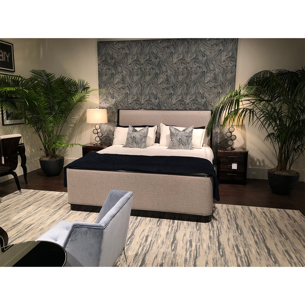 King bed in room with plants and decor.