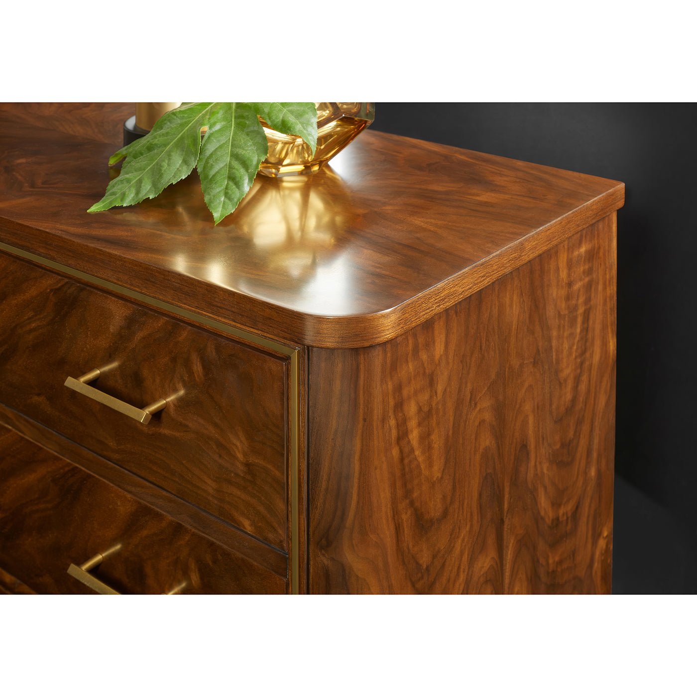Close-up of walnut bedside chest corner and decor.