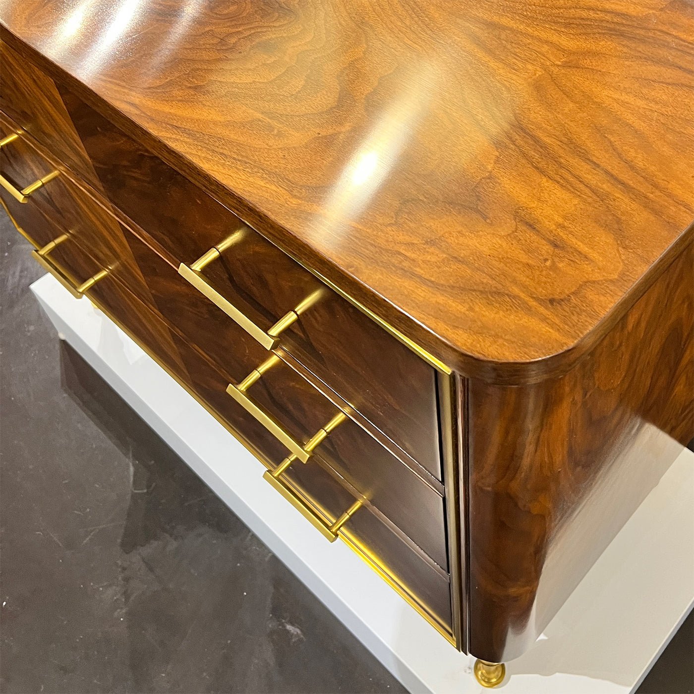 Overhead view of walnut chest top, brass handles.