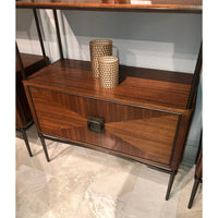 Decor items on walnut etagere in interior setting.