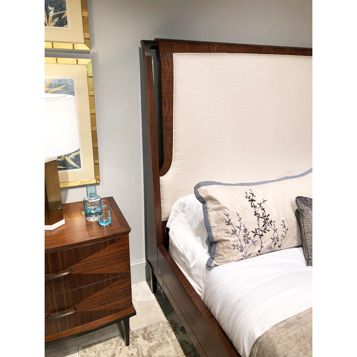 Bedside detail, upholstered headboard and nightstand.