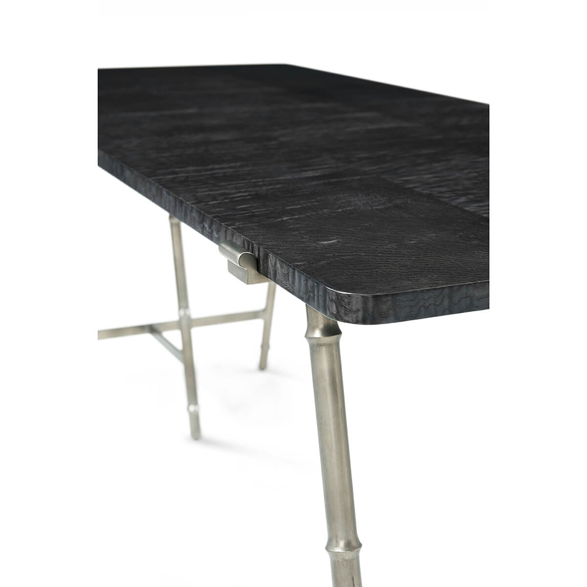 Close-up of writing table top and metal attachment.