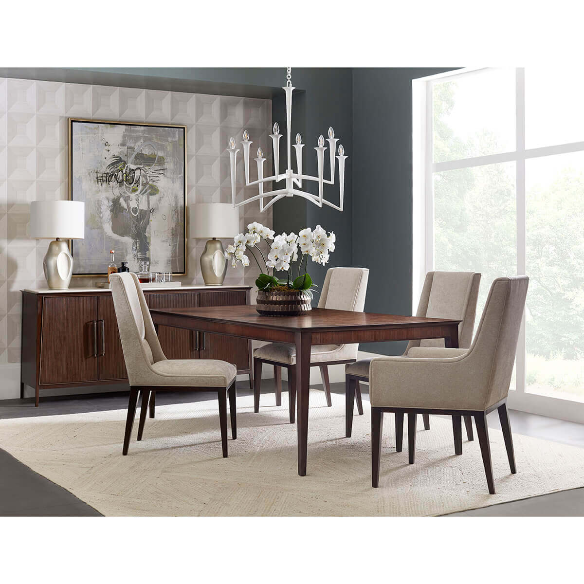 Dining room with midcentury upholstered chairs around table.