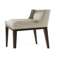 Close-up of upholstered seat and wooden legs dining chair.
