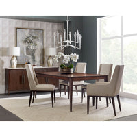 Dining room with midcentury upholstered chairs and wooden table.