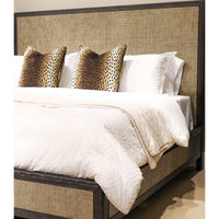 Close-up of modern bed with white bedding, decorative pillows.