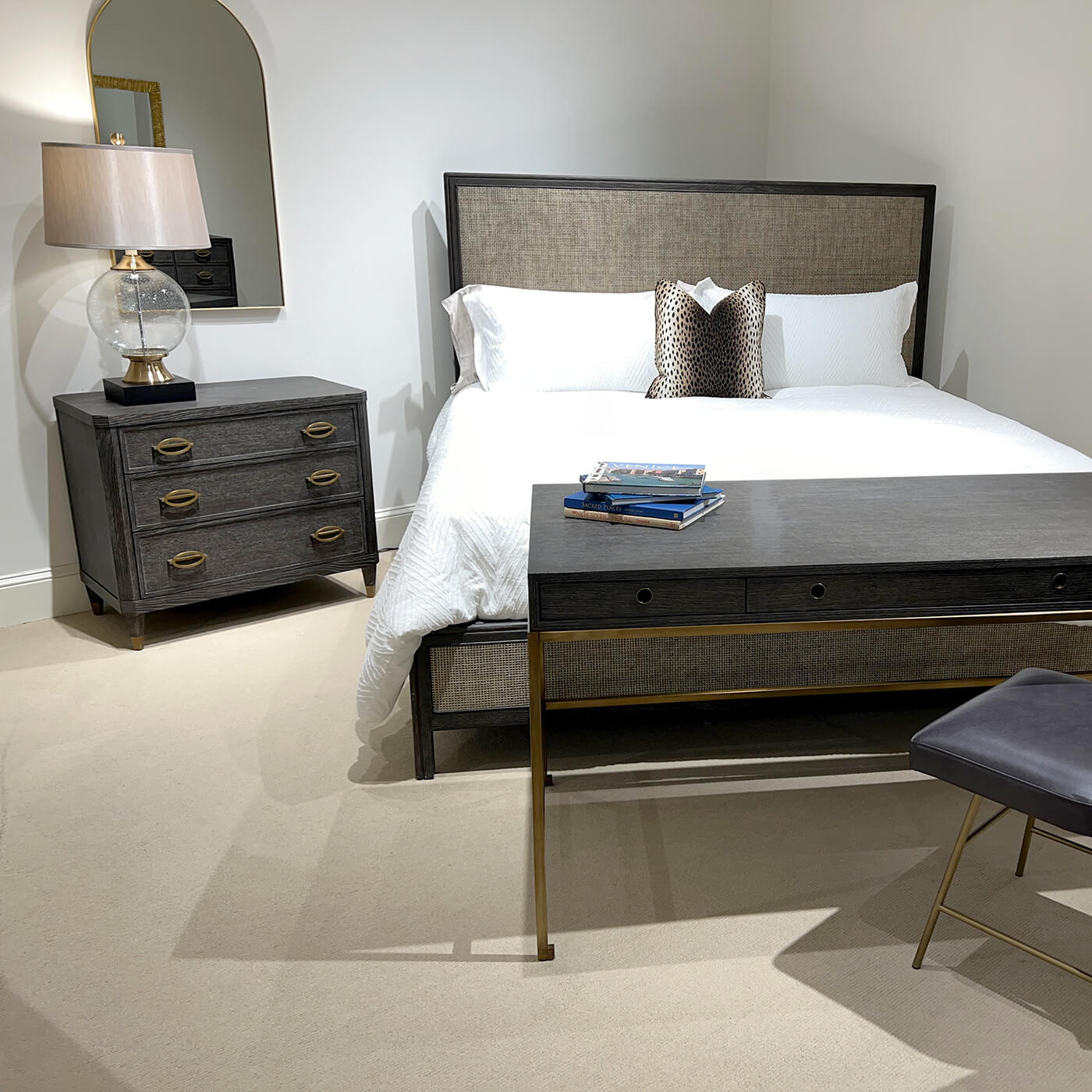 Bedroom setup featuring nightstand, bed, and decorative elements.