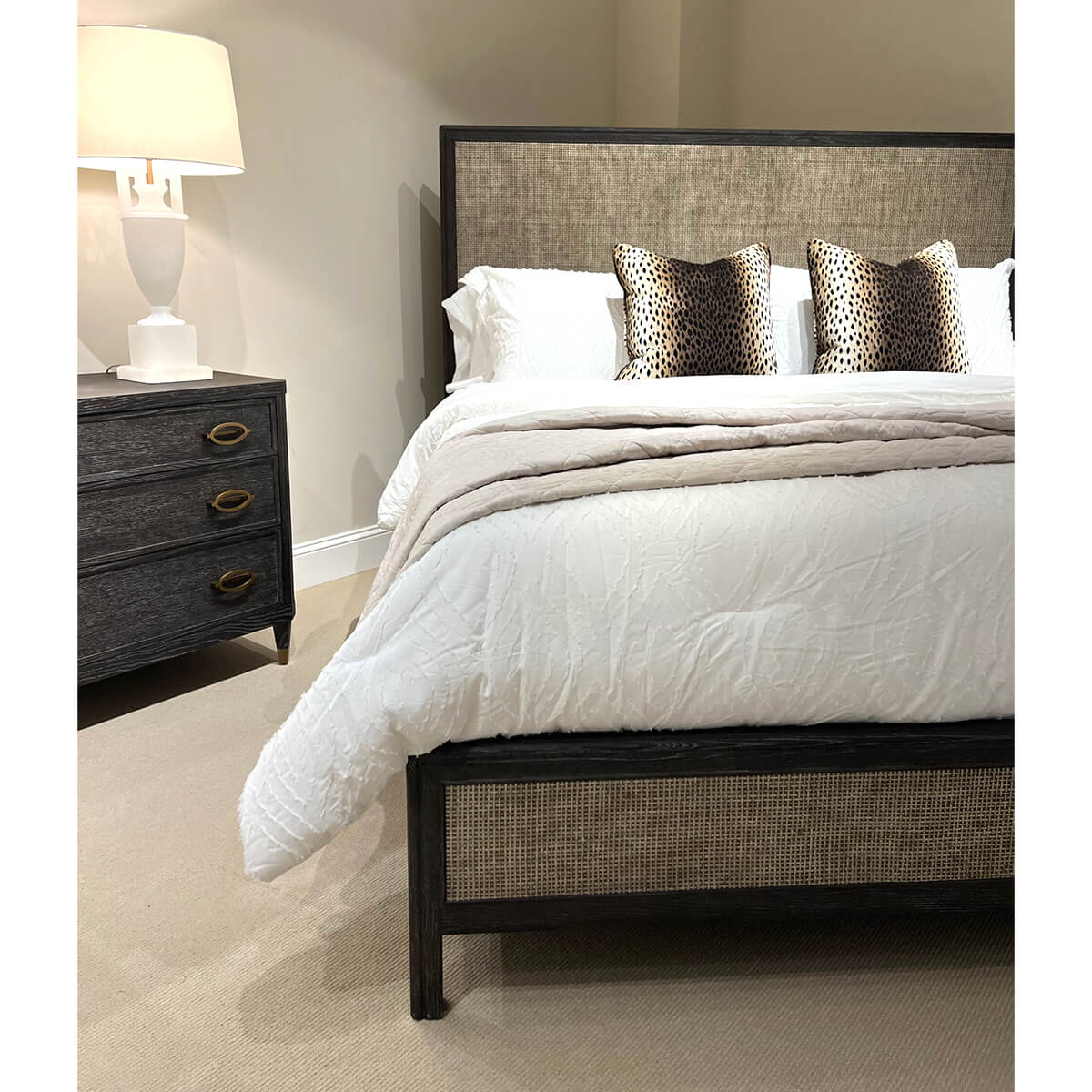 Cozy bedroom with nightstand beside bed and lampshade.