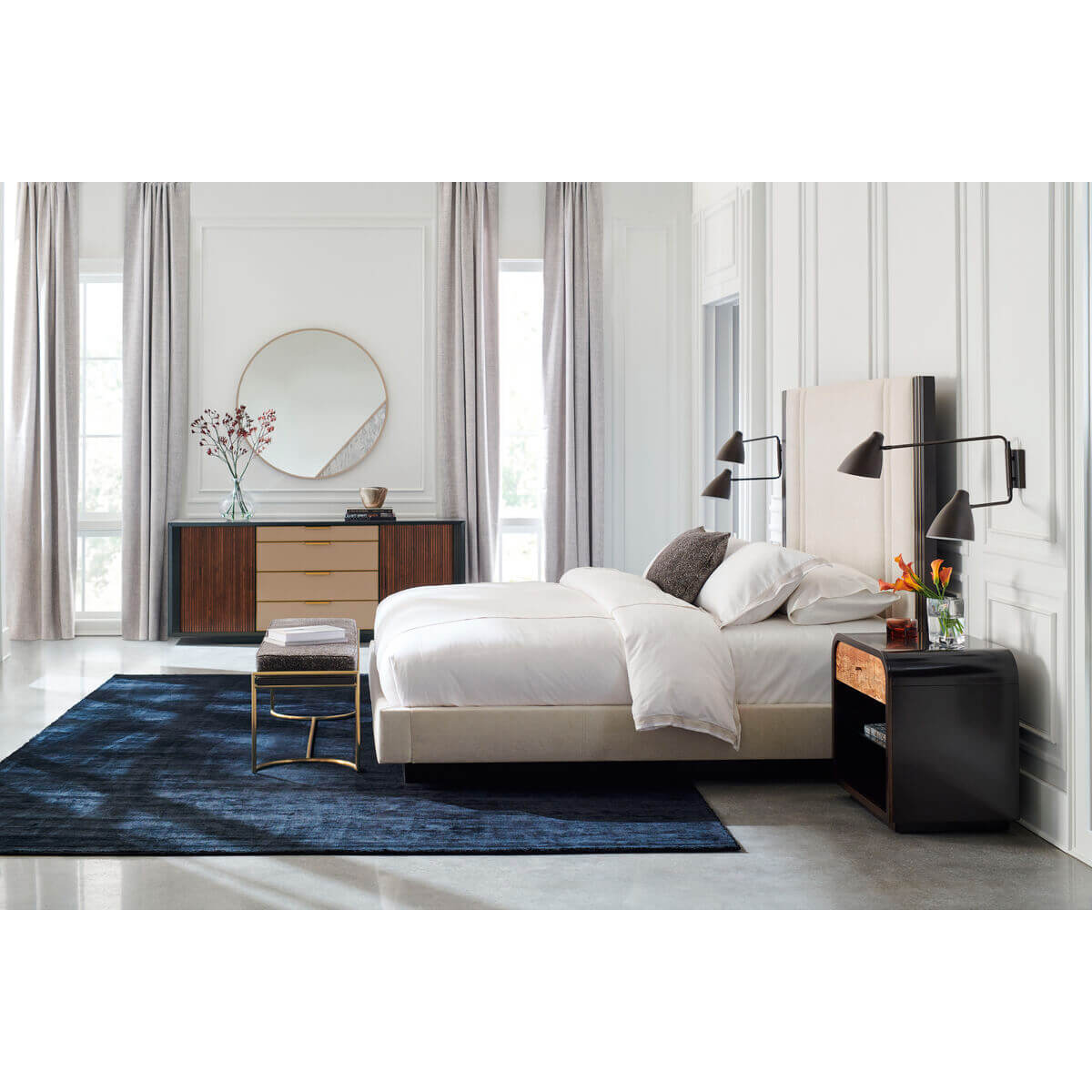 Minimalist bench in luxurious bedroom setting, wide shot.
