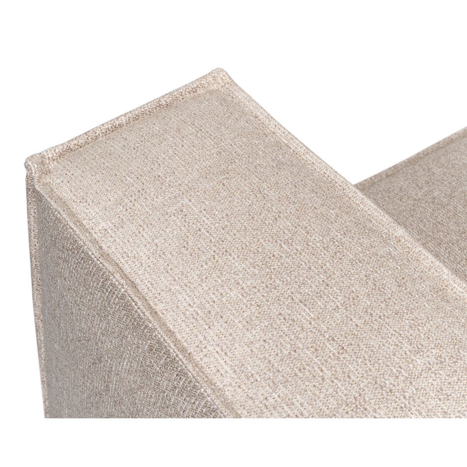 Close-up armrest of minimalist linen sofa.