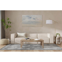 Minimalist linen sofa in styled living room setting.