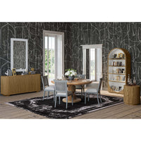 Modern bookshelf in dining room setting with furniture.