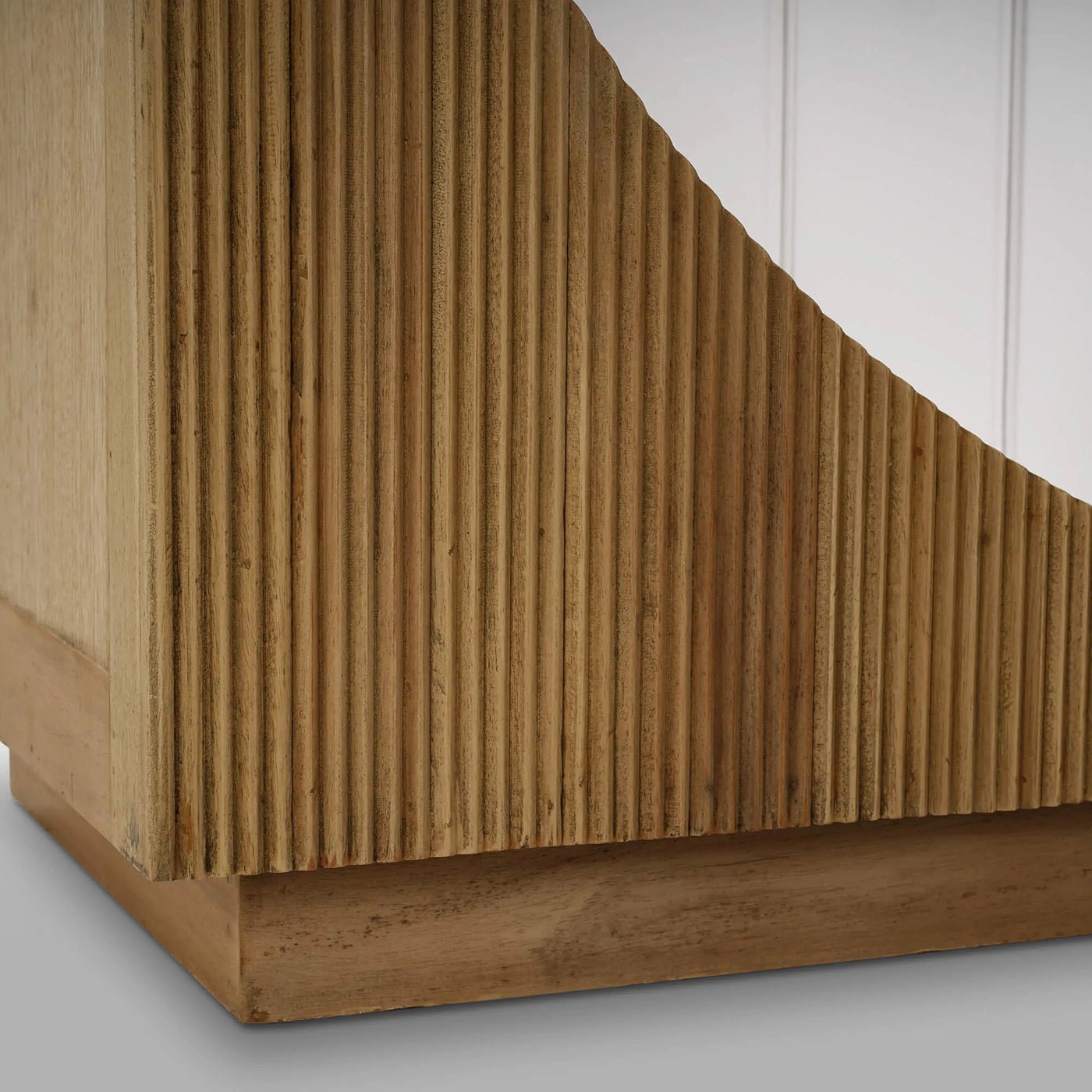 Bookshelf base close-up; wood texture and detailing.
