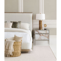 Bed with nightstand and basket, cozy setup.