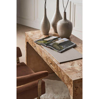 Modern barrel back armchair, desk with vases, decorative ambiance.