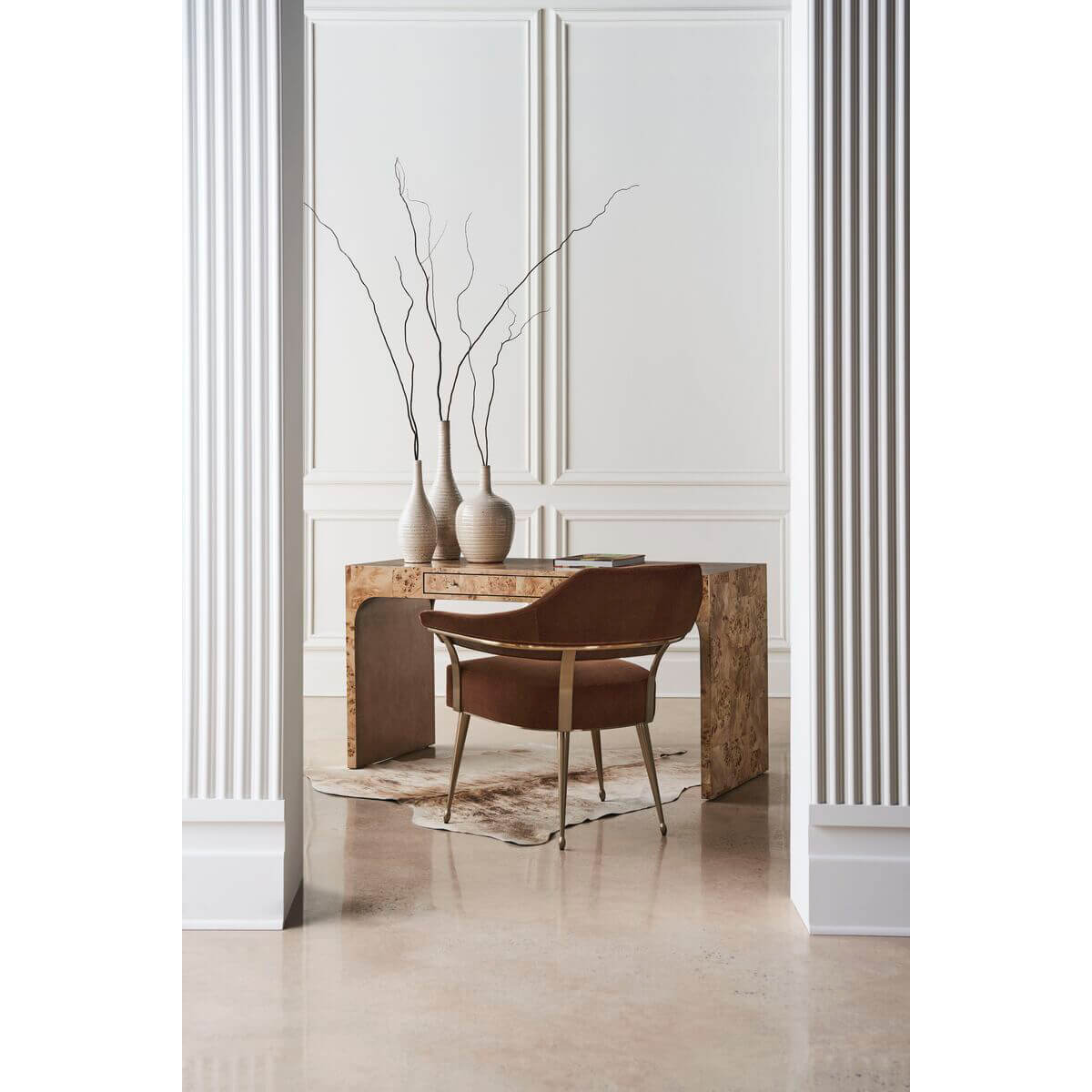 Modern barrel back armchair, at desk, minimalist decor.