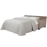 Bella sleeper sofa fully extended into bed with bedding.