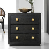 Modern black bedside chest, gold knobs, room setting.
