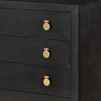 Close-up of black dresser drawers with gold knobs.