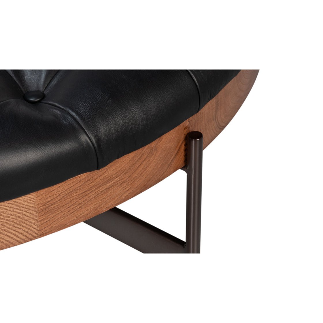 Detail view of leather upholstery and wood on ottoman.