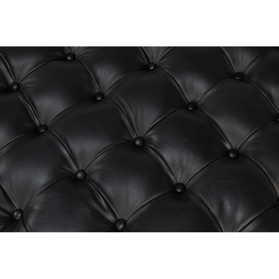 Close-up of tufted black leather surface.