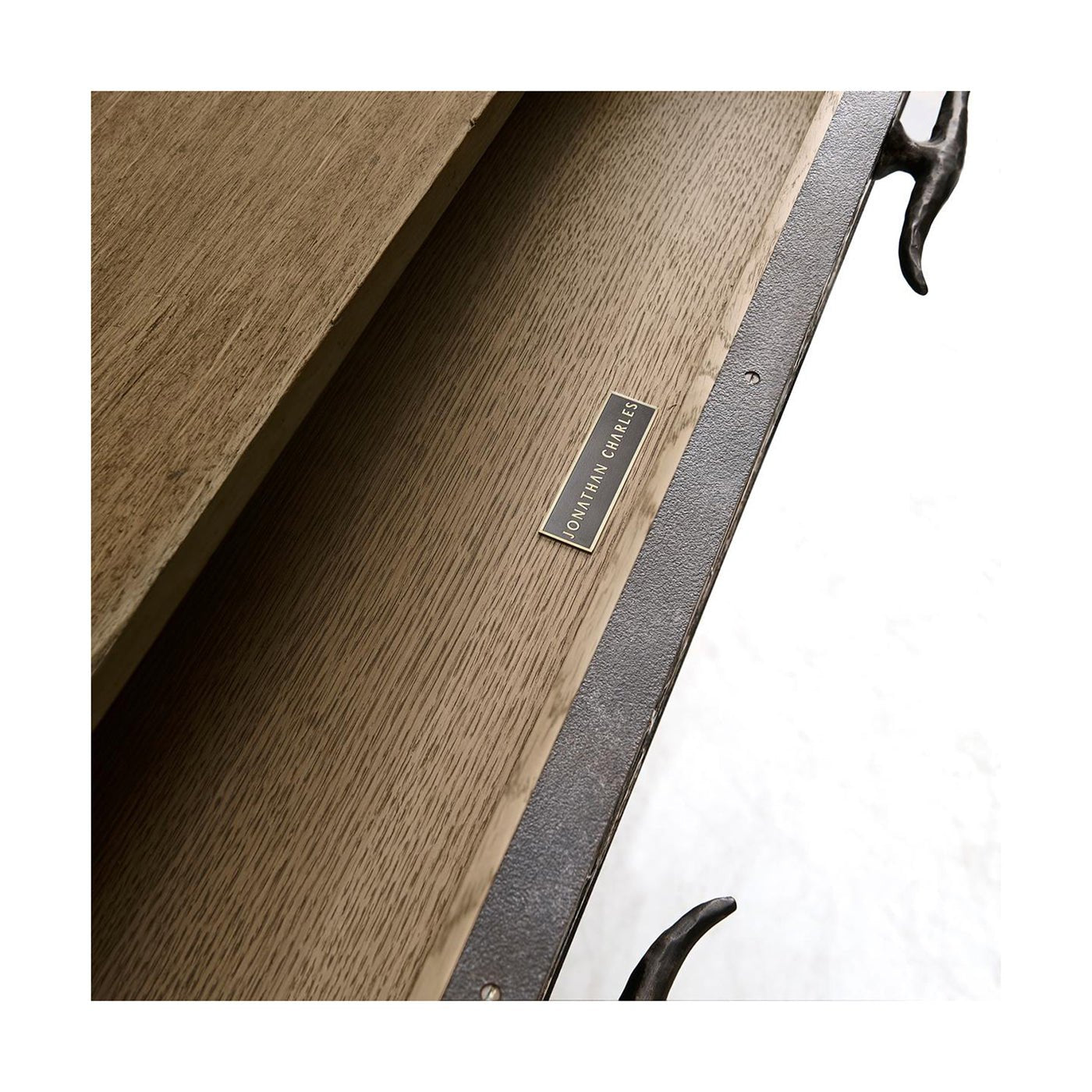 Close-up of sideboard drawer with logo plate.